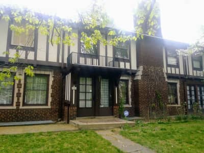 Brick and siding house with two-tone paint treatment and front porch.